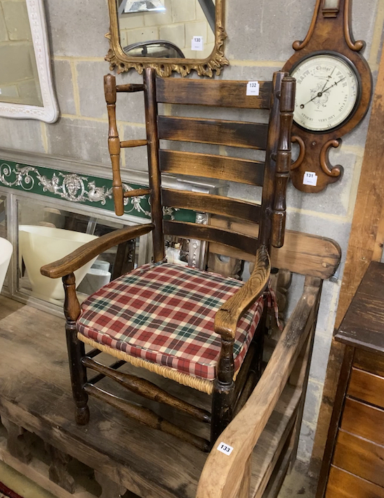 A 19th century provincial ash and elm rush seat ladder back elbow chair, width 58cm, height 108cm